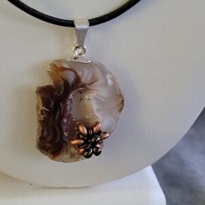 Geode pendant with flower detail on leather cord